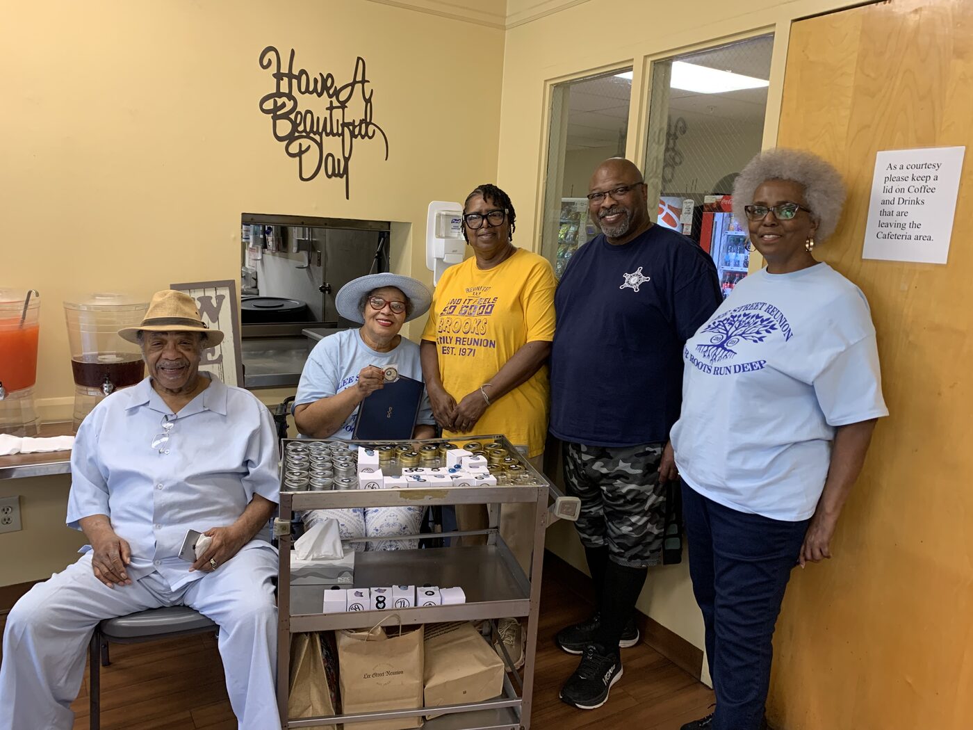 Friends gather around a cart of small gifts during a senior center visit.